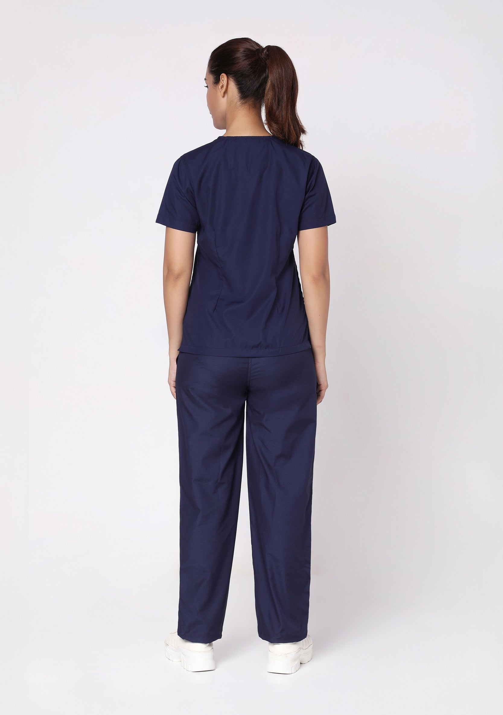 Back view of the Knya Women's Classic Scrub Top, showing its structured fit.